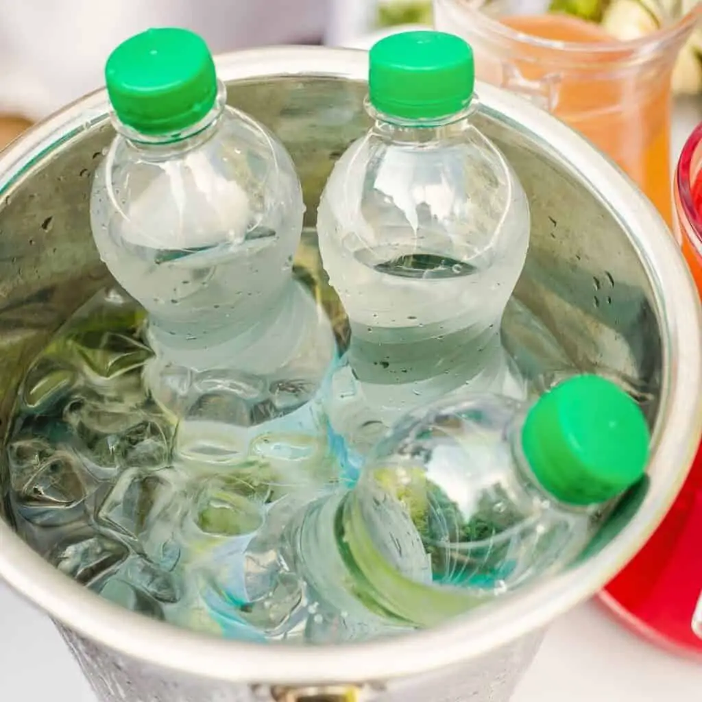 selling water at yard sale can increase your money making efforts.  image; water bottles in bucket on ice