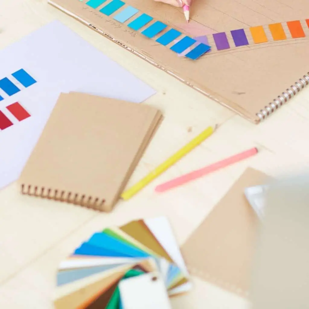 image of colored pencils, color swatches, blank paper to create colorful business vision plan